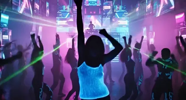 Woman dancing in a glowing fiber-optic top